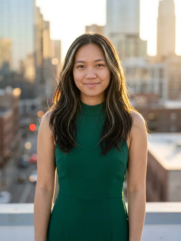 Illustrative portrait edit with an emerald dress on a rooftop at golden hour
